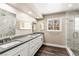 Modern bathroom with sleek dual sinks, long vanity, and glass-enclosed shower at 7229 Mira Vista St, Las Vegas, NV 89120