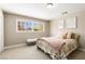 Cozy bedroom featuring soft carpet, a comfortable queen bed, and natural light from large window at 7229 Mira Vista St, Las Vegas, NV 89120