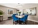 Elegant dining room with blue velvet chairs, a modern chandelier, and a large mirror at 7229 Mira Vista St, Las Vegas, NV 89120