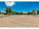 Large equestrian training space with white perimeter fence and blue skies at 7229 Mira Vista St, Las Vegas, NV 89120