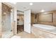 Bright main bathroom with marble-tiled shower and a luxurious soaking tub at 7229 Mira Vista St, Las Vegas, NV 89120