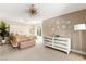 Bright main bedroom with modern chandelier, light walls, and stylish mirrored dresser at 7229 Mira Vista St, Las Vegas, NV 89120