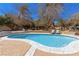 A sparkling in-ground pool is surrounded by lounge chairs and a well-kept patio, perfect for outdoor relaxation at 7229 Mira Vista St, Las Vegas, NV 89120