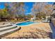 Inviting backyard featuring a sparkling pool with lounge chairs and a patio area for relaxing at 7229 Mira Vista St, Las Vegas, NV 89120