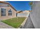 Backyard with a well-maintained putting green bordered by brick pavers and a stucco wall for privacy at 7308 Alpine Ridge St, Las Vegas, NV 89131