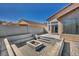 Enclosed backyard patio with paved brickwork, a central fire pit, and built-in concrete benches at 7308 Alpine Ridge St, Las Vegas, NV 89131