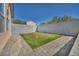 Backyard putting green is surrounded by brick pavers and a tall stucco privacy wall at 7308 Alpine Ridge St, Las Vegas, NV 89131