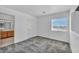 Bright bedroom featuring plush gray carpet and a window with picturesque neighborhood views at 7308 Alpine Ridge St, Las Vegas, NV 89131