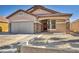 Exterior elevation of home with a two-car garage, stone accents and desert landscaping at 7308 Alpine Ridge St, Las Vegas, NV 89131