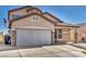 Two-story home with a wide driveway and two-car garage with brick and stone accents at 7308 Alpine Ridge St, Las Vegas, NV 89131