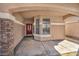 Covered front porch featuring stone columns and a red front door with decorative window panes at 7308 Alpine Ridge St, Las Vegas, NV 89131