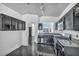 Modern kitchen with sleek black cabinets, granite countertops, and stainless steel appliances at 7308 Alpine Ridge St, Las Vegas, NV 89131