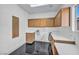 A well-lit laundry room with sleek cabinets and counter space, and a window at 7308 Alpine Ridge St, Las Vegas, NV 89131