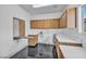 A well-lit laundry room with sleek cabinets, counter space, and a convenient fold-down ironing board at 7308 Alpine Ridge St, Las Vegas, NV 89131