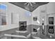 Bright living room with a high ceiling, modern fireplace and view into the kitchen at 7308 Alpine Ridge St, Las Vegas, NV 89131