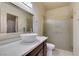 Bathroom featuring vessel sink, white countertop, dark cabinets and glass enclosed shower at 8301 Boseck Dr # 215, Las Vegas, NV 89145