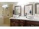 Bathroom with double vessel sinks and a glass shower at 8301 Boseck Dr # 215, Las Vegas, NV 89145