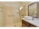 Bathroom with single vessel sink, dark cabinets, and accessible glass enclosed shower at 8301 Boseck Dr # 215, Las Vegas, NV 89145