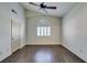 Vaulted ceiling bedroom with wood floors, fan, and large window with white shutters at 8301 Boseck Dr # 215, Las Vegas, NV 89145