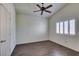 Bedroom with dark wood-look floors, a ceiling fan, a window, and a neutral color scheme at 8301 Boseck Dr # 215, Las Vegas, NV 89145