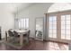 Bright dining area featuring modern lighting, sleek hardwood floors, and doors to the outside at 8301 Boseck Dr # 215, Las Vegas, NV 89145