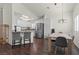 Bright dining area featuring modern lighting, sleek hardwood floors, and stainless steel appliances in the adjacent kitchen at 8301 Boseck Dr # 215, Las Vegas, NV 89145