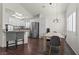 Bright dining area featuring modern lighting, sleek hardwood floors, and stainless steel appliances in the adjacent kitchen at 8301 Boseck Dr # 215, Las Vegas, NV 89145