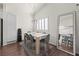 Bright dining area featuring modern lighting, sleek hardwood floors, and white shutters on the windows at 8301 Boseck Dr # 215, Las Vegas, NV 89145