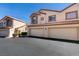 Well-maintained townhomes boasting two-car garages, desert landscaping, and appealing architectural details at 8301 Boseck Dr # 215, Las Vegas, NV 89145