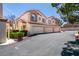 Inviting townhome featuring a three-car garage, desert landscaping, and a charming tiled roof at 8301 Boseck Dr # 215, Las Vegas, NV 89145