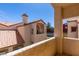 Exterior view of the property showing tiled roof and partial balcony with stucco facade at 8301 Boseck Dr # 215, Las Vegas, NV 89145
