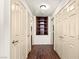 Hallway with a built-in bookcase and paneled doors with brushed nickel handles at 8301 Boseck Dr # 215, Las Vegas, NV 89145