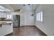 Eat-in kitchen area with stainless refrigerator, white cabinets and shuttered window at 8301 Boseck Dr # 215, Las Vegas, NV 89145