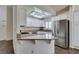 Bright kitchen with white cabinets, granite countertops, stainless steel refrigerator, and lots of natural light at 8301 Boseck Dr # 215, Las Vegas, NV 89145