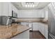 Well-lit kitchen featuring granite countertops, stainless steel appliances, and white cabinetry at 8301 Boseck Dr # 215, Las Vegas, NV 89145