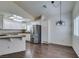 Eat-in kitchen area with stainless refrigerator, white cabinets and stone countertops at 8301 Boseck Dr # 215, Las Vegas, NV 89145