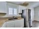 Kitchen area featuring granite countertops, a stainless steel refrigerator, white cabinets, and lots of light at 8301 Boseck Dr # 215, Las Vegas, NV 89145
