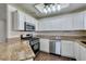 Modern kitchen featuring stainless steel appliances, granite countertops, white cabinets, and a stylish design at 8301 Boseck Dr # 215, Las Vegas, NV 89145
