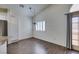 Eat-in kitchen with stainless refrigerator, white cabinets and wood floors at 8301 Boseck Dr # 215, Las Vegas, NV 89145