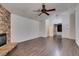 Spacious living room with stone fireplace, wood floors, and ceiling fan at 8301 Boseck Dr # 215, Las Vegas, NV 89145