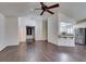 Open living space with wood floors and view into kitchen with stainless refrigerator at 8301 Boseck Dr # 215, Las Vegas, NV 89145