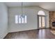 Living room with stone fireplace, wood floors, and shuttered windows at 8301 Boseck Dr # 215, Las Vegas, NV 89145