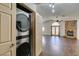 Living area featuring a stacked washer/dryer with a view of a fireplace and an arched entryway at 8301 Boseck Dr # 215, Las Vegas, NV 89145