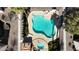 Overhead view of a uniquely shaped pool and hot tub surrounded by lush landscaping and lounge chairs at 8301 Boseck Dr # 215, Las Vegas, NV 89145