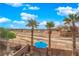 This backyard has palm trees, a custom patio, and views of the golf course at 8349 Spruce Bay Ave, Las Vegas, NV 89178