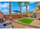 Backyard featuring a green lawn, palm trees and seating at 8349 Spruce Bay Ave, Las Vegas, NV 89178