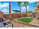 Private backyard featuring artificial turf area and decorative landscaping at 8349 Spruce Bay Ave, Las Vegas, NV 89178