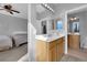 Bright bathroom with white countertops, wood cabinets, and access to the bedroom at 8349 Spruce Bay Ave, Las Vegas, NV 89178