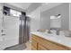 Functional bathroom featuring a shower-tub, wood cabinets, and a large mirror at 8349 Spruce Bay Ave, Las Vegas, NV 89178