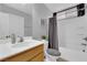 Well-lit bathroom featuring a shower-tub combo, wooden vanity, and neutral color palette at 8349 Spruce Bay Ave, Las Vegas, NV 89178